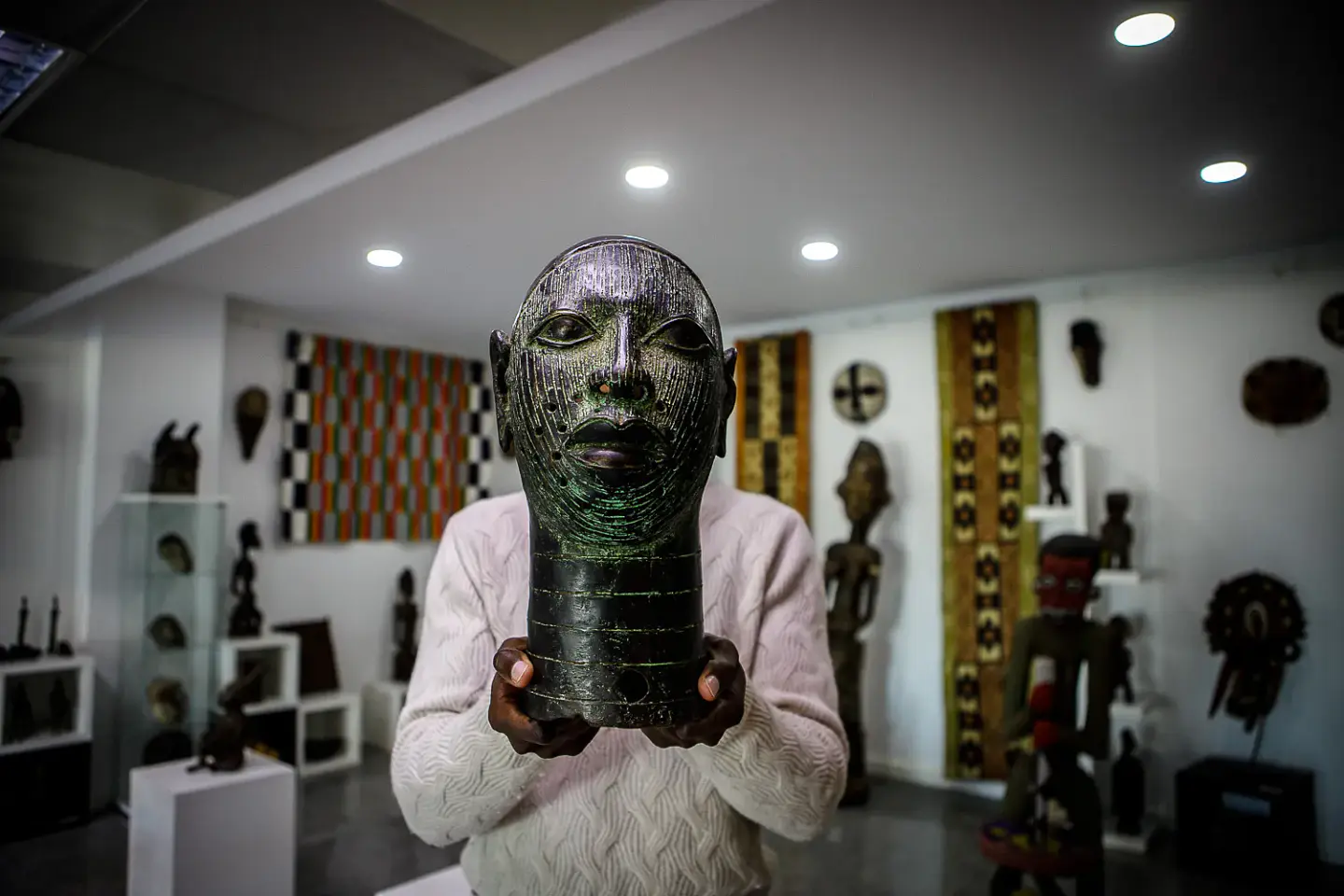 African bronze head sculpture presented inside Afrika Infinity, an African ethnographic art gallery in Lisbon, Portugal.