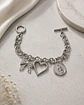 Pulsera Plateada de Eslabones con 3 Dijes Corazón Moño Virgen - Miniatura 1
