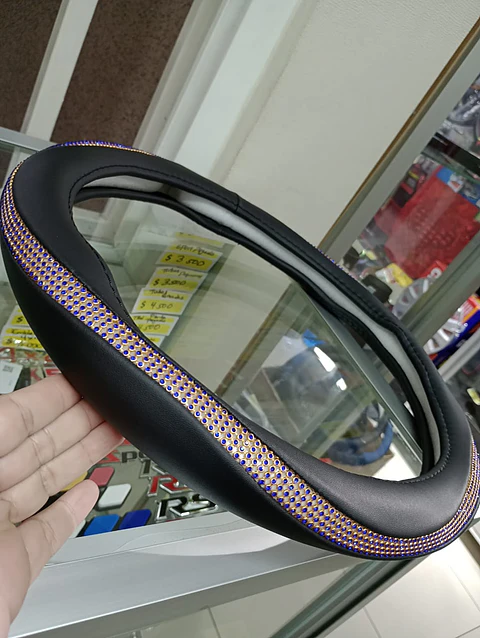 Forro cubre volante damas, negro/dorado con cristales azul
