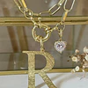 Collar Inicial R con punto de luz Gold