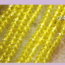 Cristal facetado de color amarillo 2 x 2 mm, tira de 165 cristales aprox  (la medida de los cristales varía en 0.3 mm aprox)
