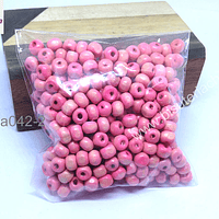 Cuenta de madera color rosado 6 mm, bolsa de 25 grs.