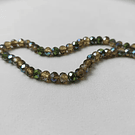 Cristal facetado de 6 mm, color verde t café tornasol, tira de 85 cristales aprox.