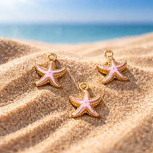 dije esmaltado estrella de mar rosa base dorado, 15 mm, por unidad