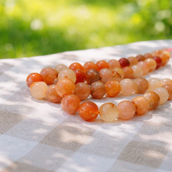 Agata de 10 mm, en tonos naranjos y crema, tira de 37 piedras aprox.