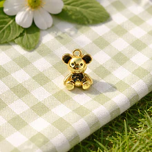 Colgante Oso, baño de oro, con esmaltado negro, 17 x 12 mm. por unidad