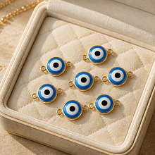 Conector ojo turco doble conexión, con borde baño de oro, 18 x 11 mm, por unidad