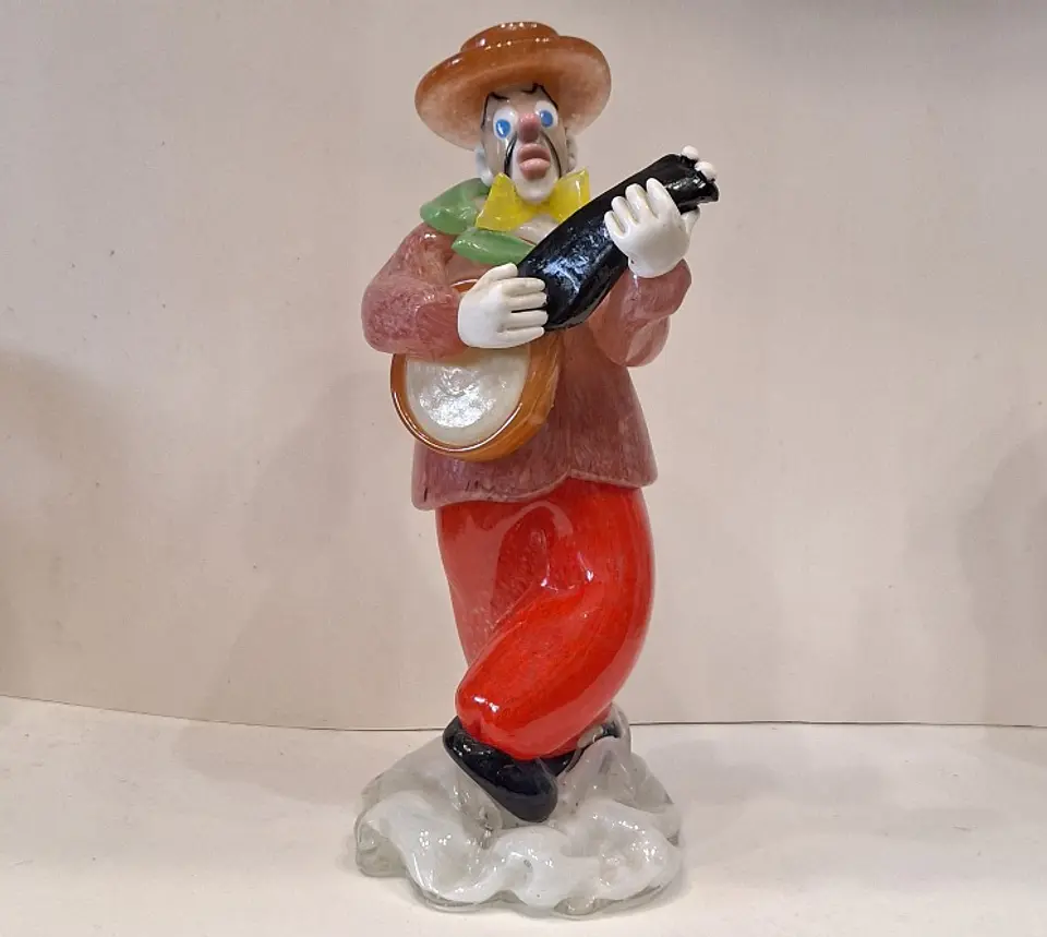 Estatueta de vidro representando palhaço músico.  1