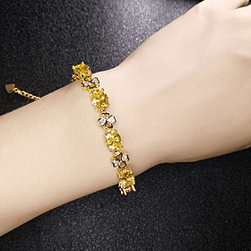 Pulsera con movimiento y diseños de trébol con zafiro amarillo de imitación corte oval y circonias blancas en cobre chapado en oro amarillo