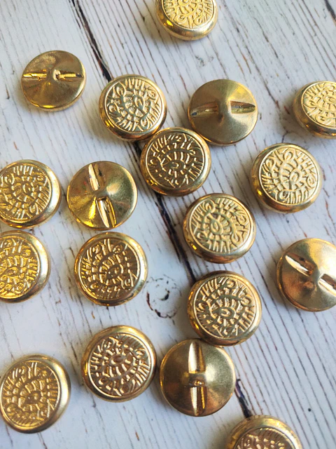 Botones Plumas dorados unidad