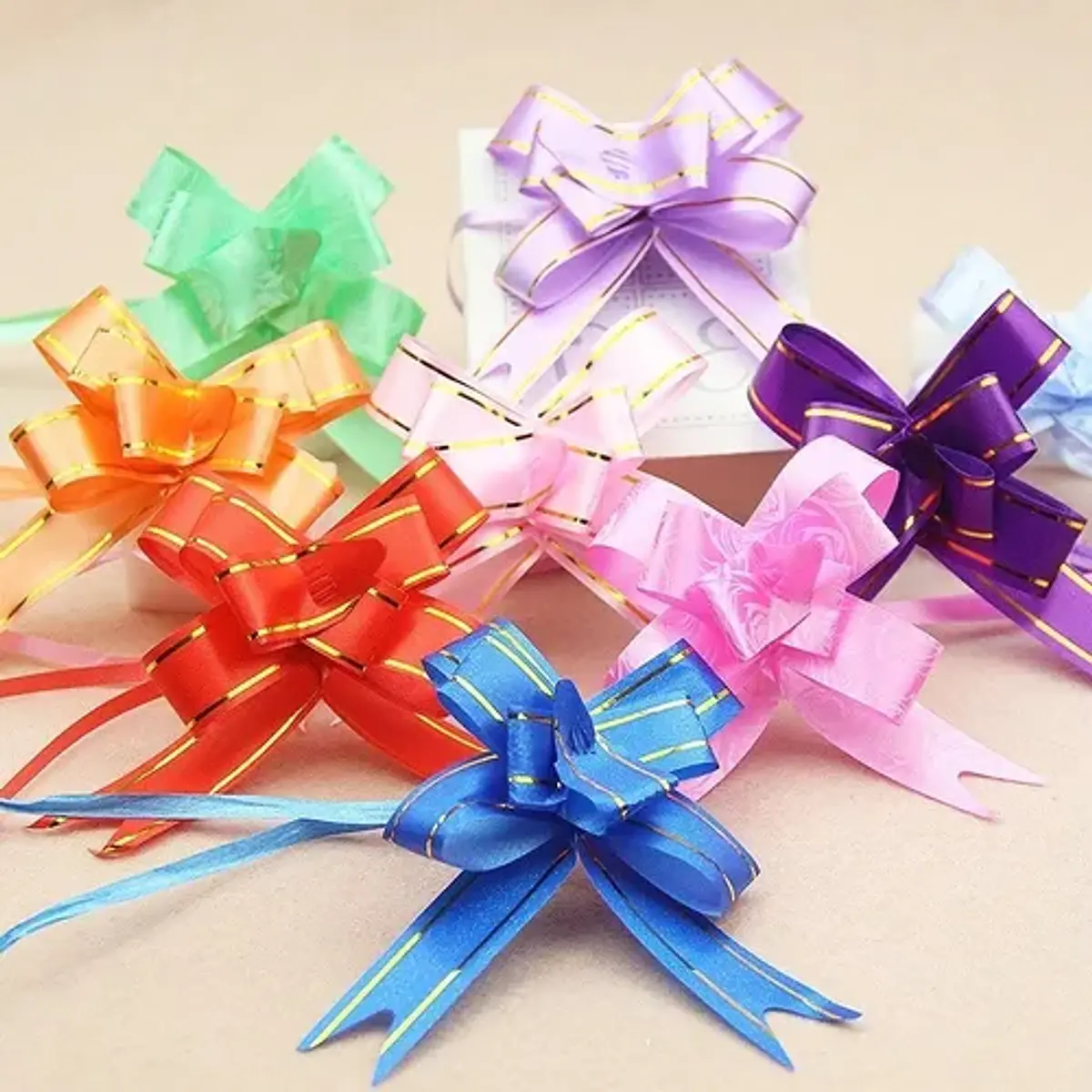 CINTA DE REGALO MÁGICA MOÑO 1.4x25.5CMS PQT 10 UNDS POR COLO