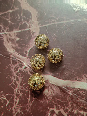 Entremeio bola dourado/prata com strass interno