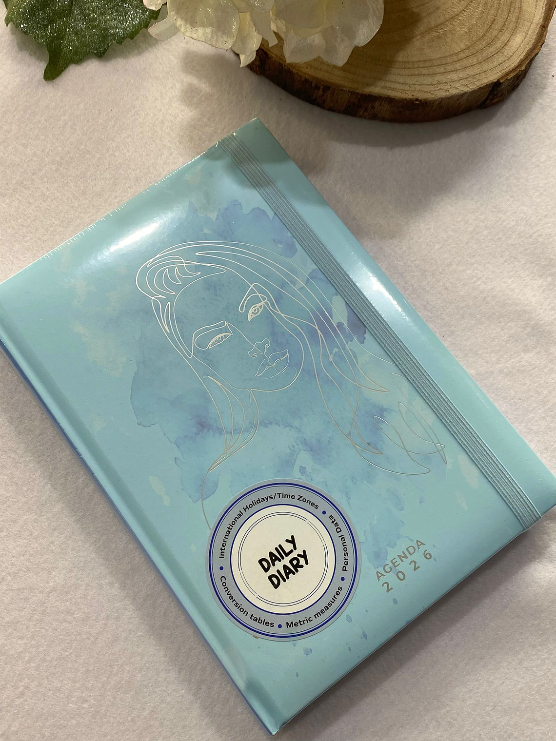 Agenda azul com rosto dourado 2026 1