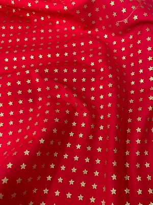 Tecidos vermelho com estrelinhas  douradas pequenas 