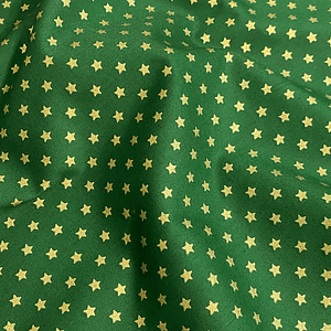 Tecido verde com estrelinhas douradas pequenas