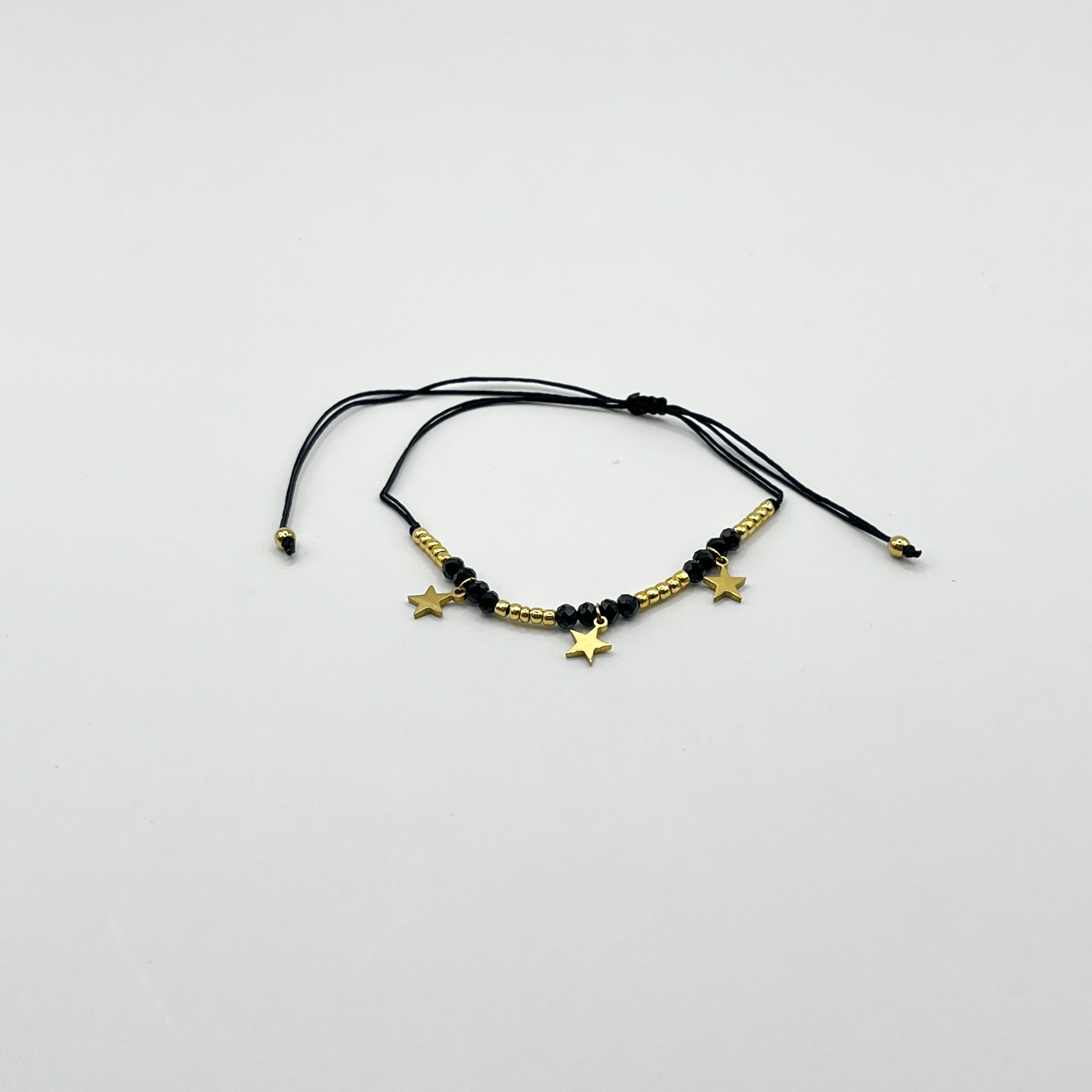 Pulsera de acero quirúrgico negra con estrellas doradas ajustable 1