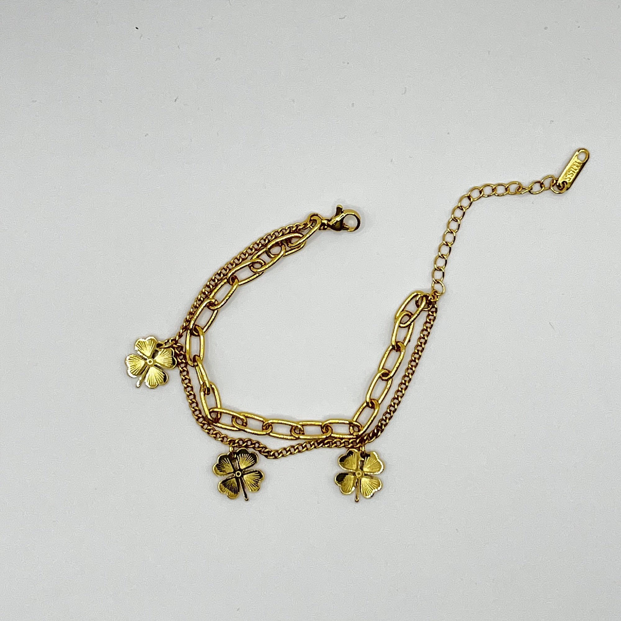 Pulsera de acero quirúrgico dorada doble cadena con tréboles 1