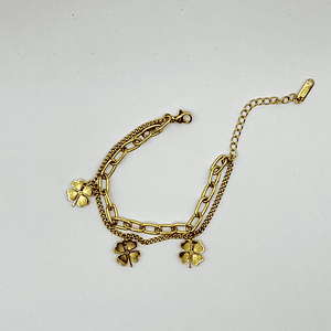 Pulsera de acero quirúrgico dorada doble cadena con tréboles