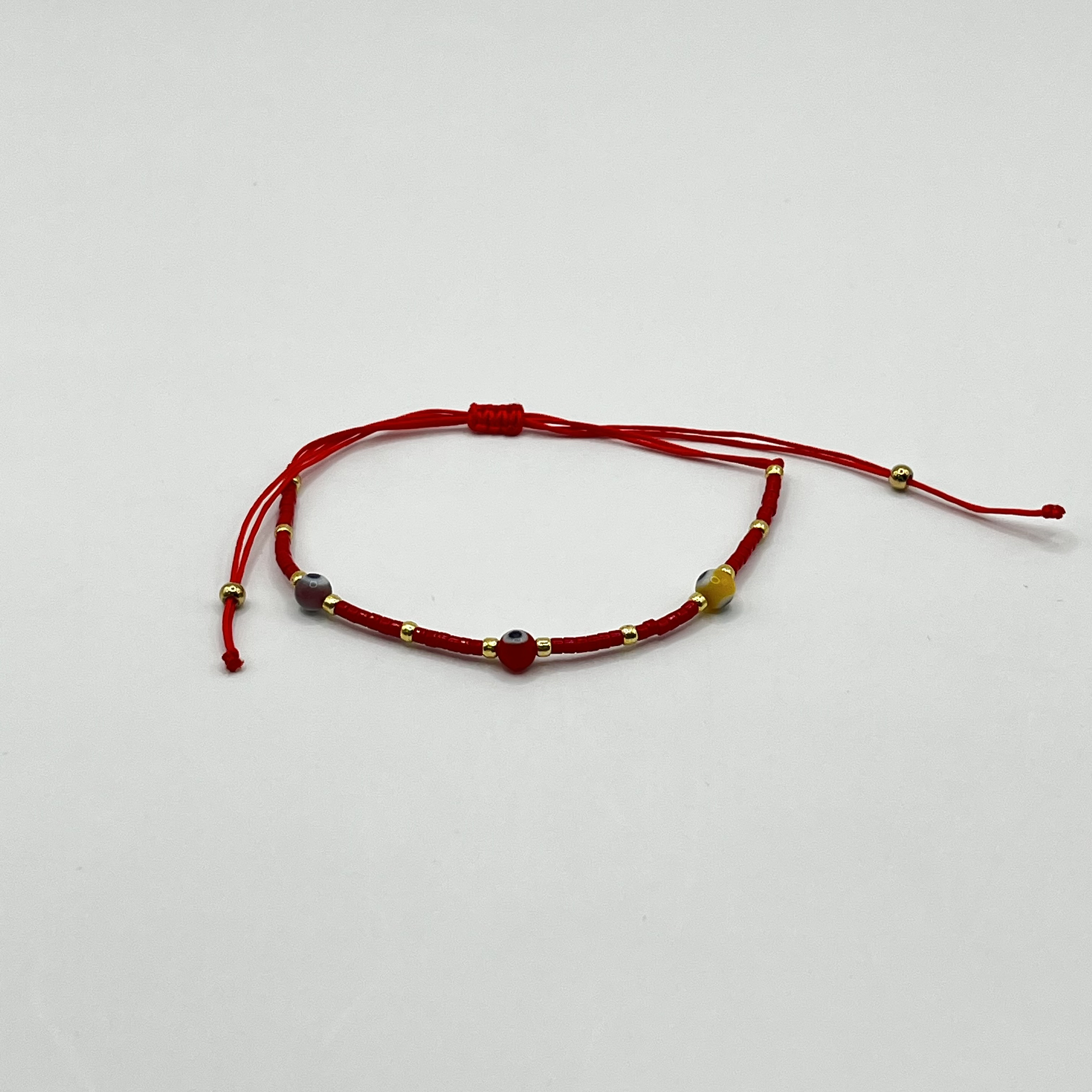 Pulsera de acero quirúrgico roja con ojitos ajustable 1