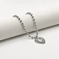 Collar de acero quirúrgico plateado de esferas con corazón sagrado - Miniatura 3
