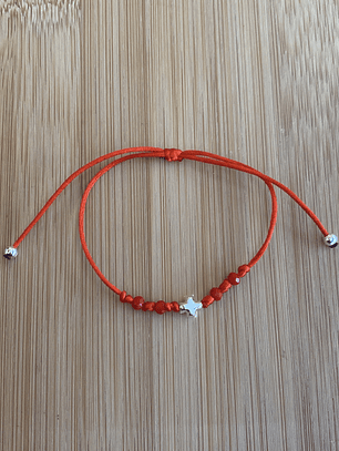 Pulsera de hilo rojo con una cruz