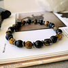 Pulsera unisex creada con Ojo de tigre facetado, Onix y separadores de Hematitas 2