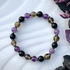Pulsera femenina creada con Amatistas, Cuarzo ahumado y Ónix negro mate, acompañada por separadores de Hematitas. 1