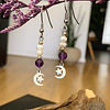 Aros creados en acero con cristales de Amatistas facetadas y Perlas de río, acompañados por dijes de luna y estrellas. 1