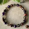 Pulsera masculina creada con Ojo de buey, Cuarzo ahumado, Ojo de gato morado y separadores de Hematitas. 1