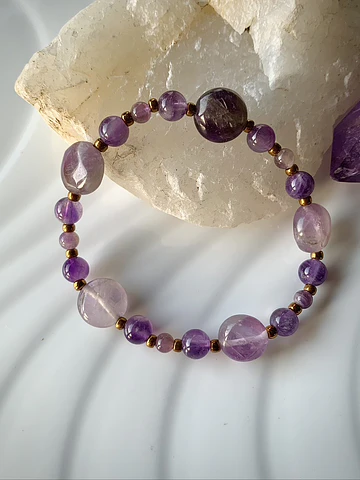 Pulsera femenina creada con Amatistas y mostacillas metalizadas doradas.