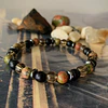 Pulsera unisex creada con Unakita, Ónix negro mate, Cuarzo Ahumado y Hematita. 1