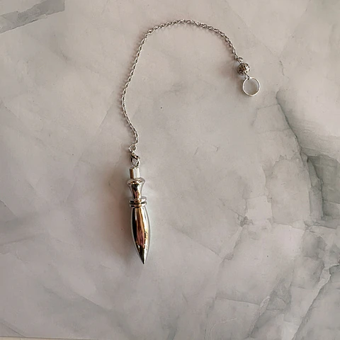 Péndulo metalico plateado