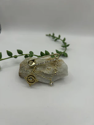 Prendedor ojo protector 