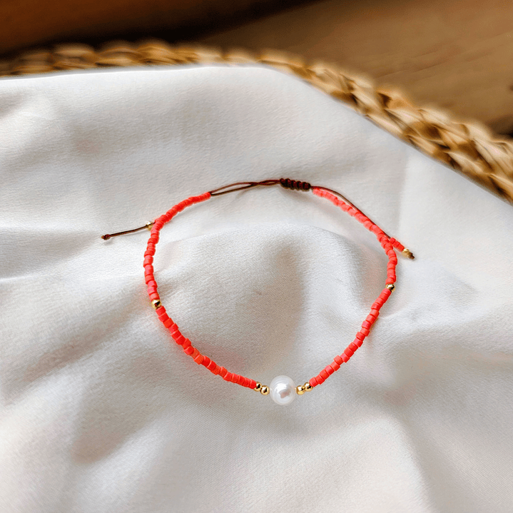 Pulsera naranja una perla 1