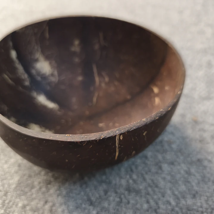 Una colección de cuatro artículos: dos cuencos de coco y dos cucharas de madera 2