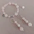 Conjunto de pulsera y aros de piedras de cuarzo rosa