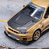 Mini GT 1:64 Nissan Skyline GT-R (R34) Top Secret – Gold – Japan Exclusive.