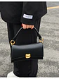 Bolso de hombro negro con cierre dorado y asa rígida — estilo urbano minimalista - Miniatura 1