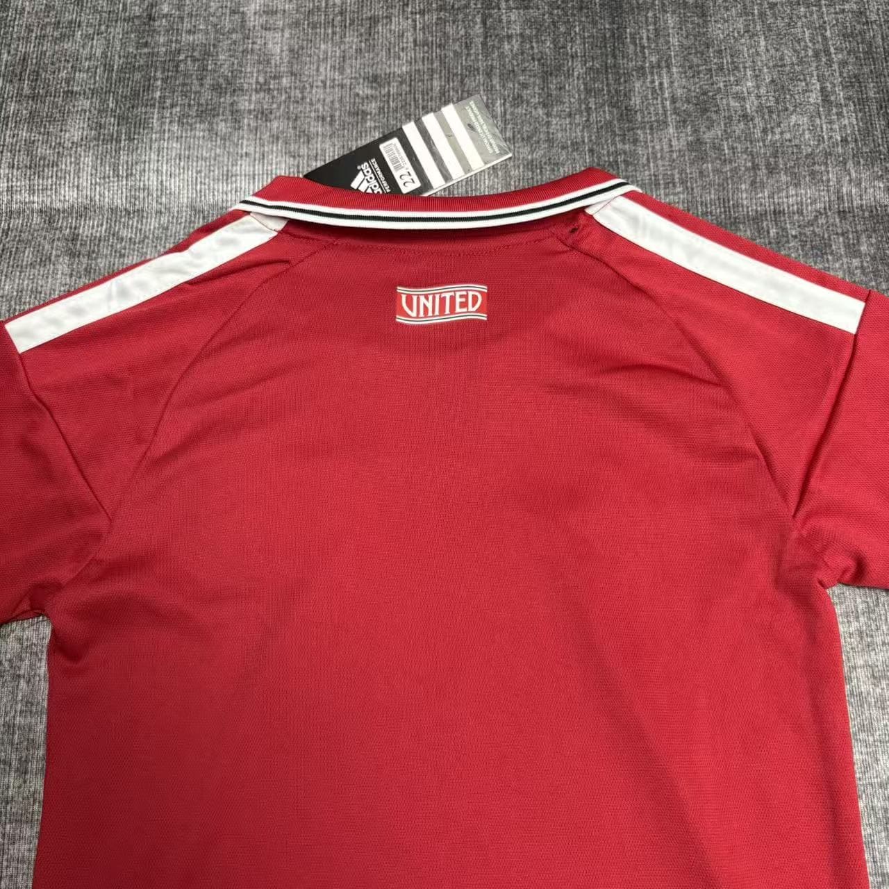 Kit Criança Manchester United principal 26/27 7