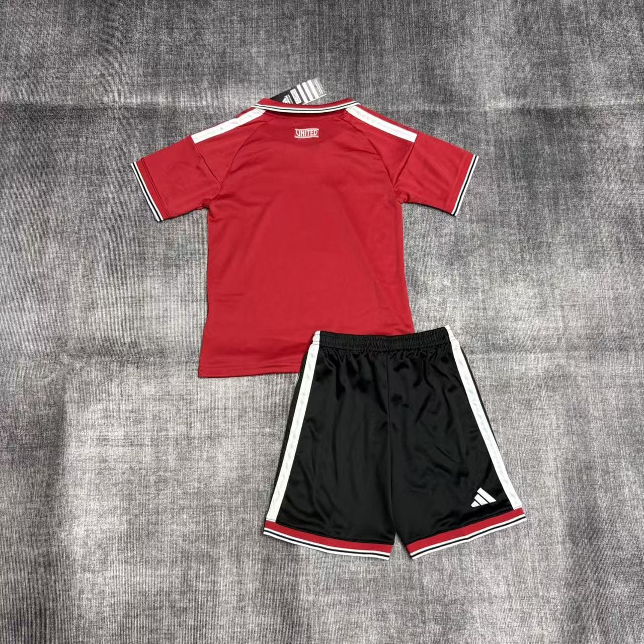 Kit Criança Manchester United principal 26/27 2