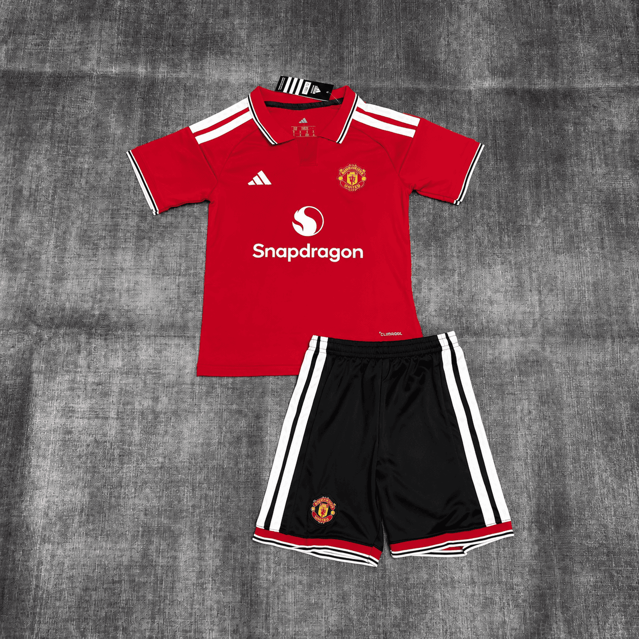 Kit Criança Manchester United principal 26/27 1