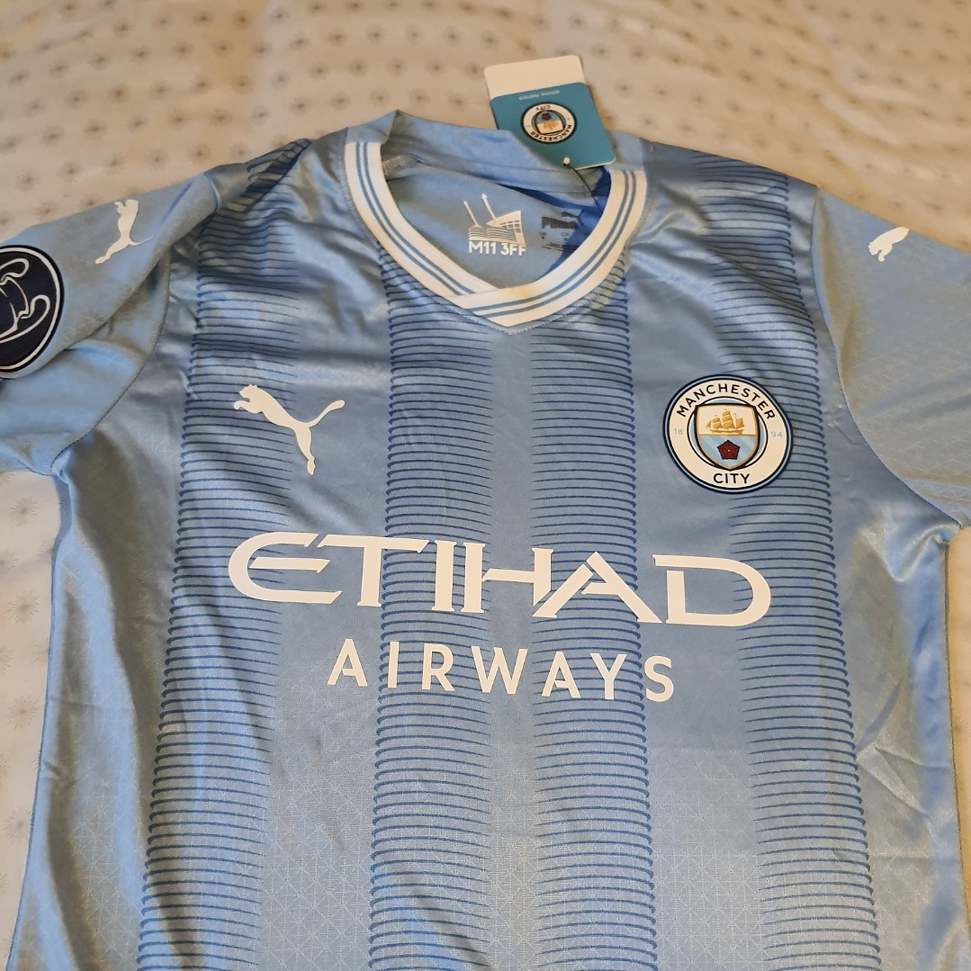 Camiseta  Manchester City  F. C.  Hombre Local  23/24 Versión Jugador con Parche UCL  Talla 