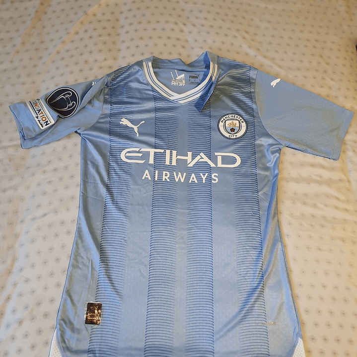 Camiseta  Manchester City  F. C.  Hombre Local  23/24 Versión Jugador con Parche UCL  Talla 