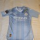 Camiseta  Manchester City  F. C.  Hombre Local  23/24 Versión Jugador con Parche UCL  Talla 