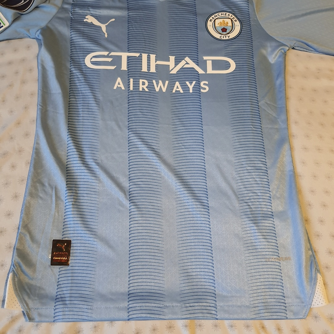 Camiseta  Manchester City  F. C.  Hombre Local  23/24 Versión Jugador con Parche UCL  Talla 