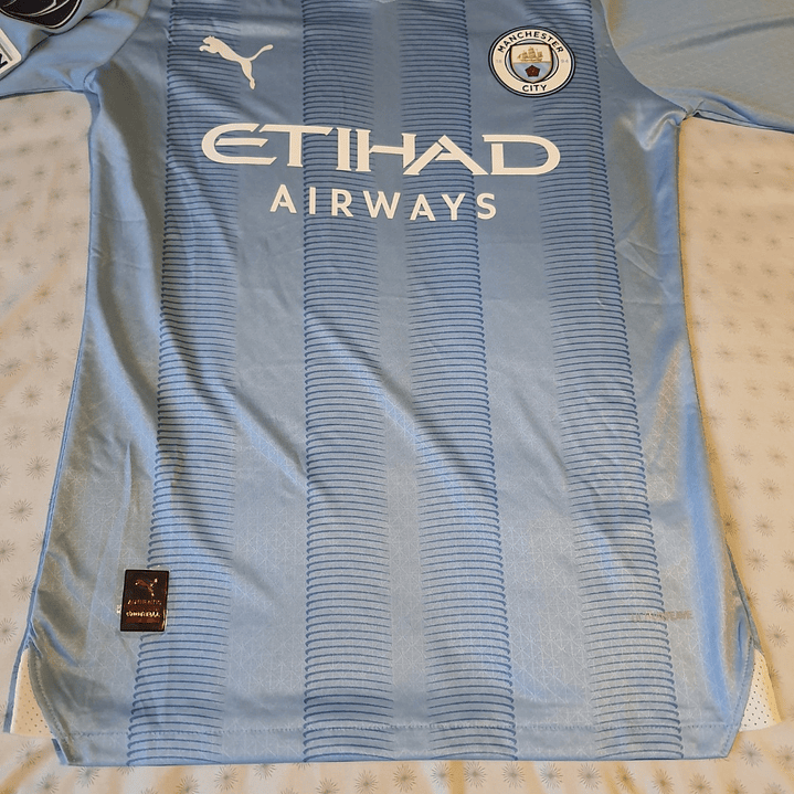 Camiseta  Manchester City  F. C.  Hombre Local  23/24 Versión Jugador con Parche UCL  Talla 