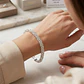 Pulsera plata circular con dijes - Miniatura 2