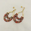 Aros gotas doradas con cristales rojos