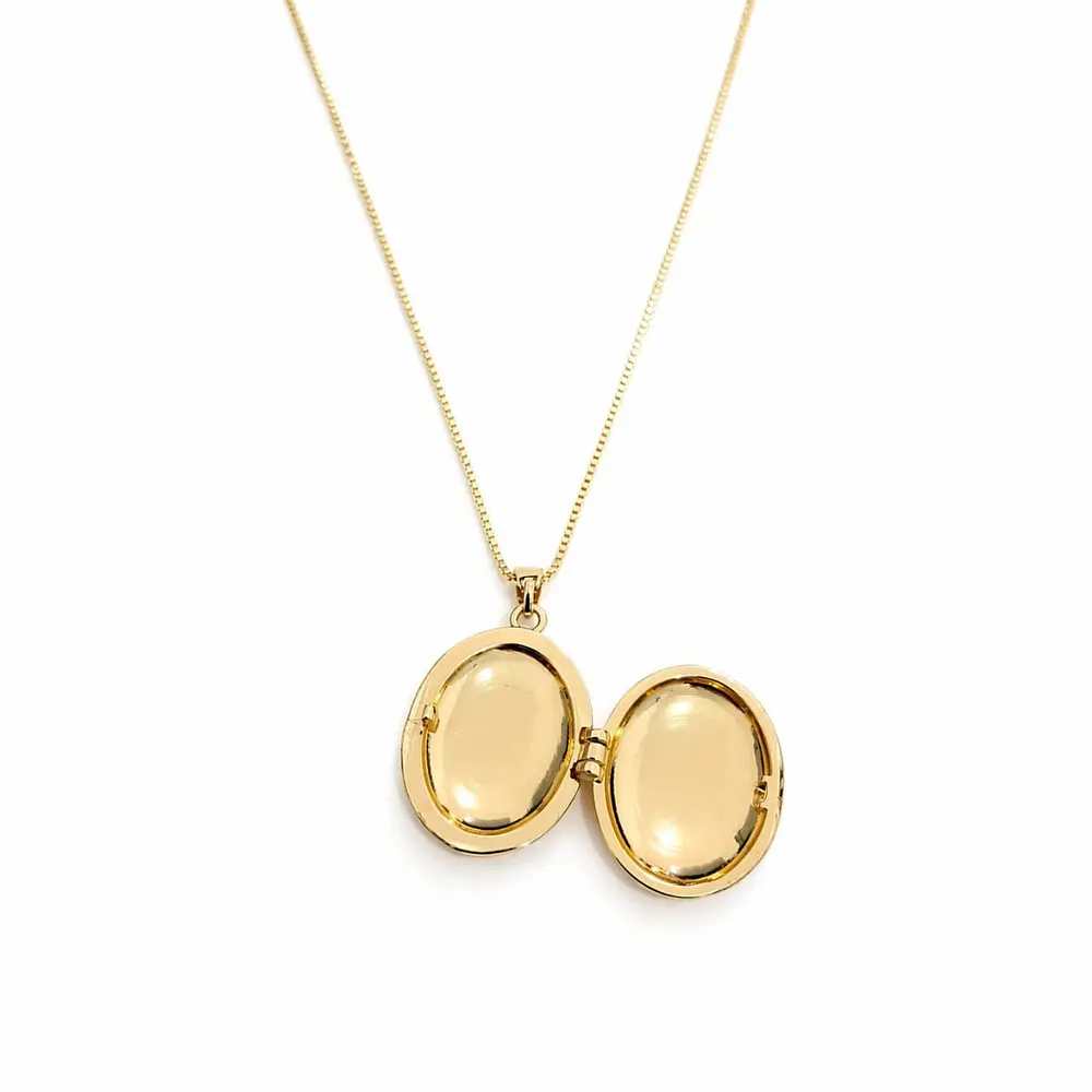 Relicario ovalado amarillo con diseño de flores blancas