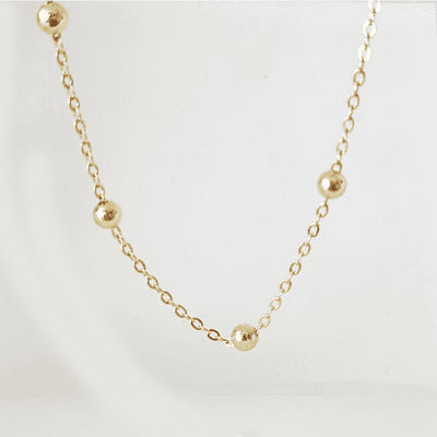 collar bolitas doradas